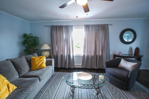 a living room with a couch and a glass table at Abundant Seed in Rosedale