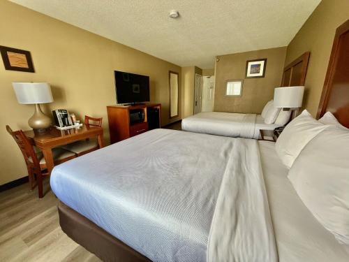 a hotel room with two beds and a television at Comfort Inn Gurnee near Six Flags in Gurnee