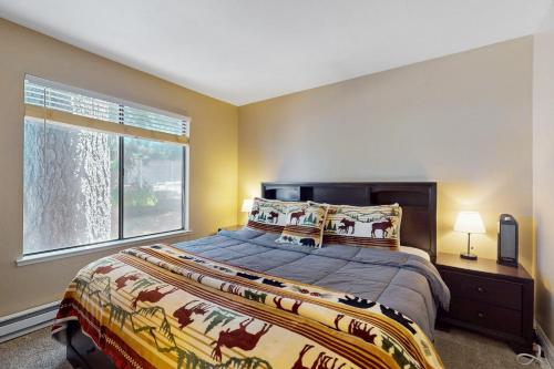 a bedroom with a large bed and a window at 11529 Snowpeak Way #619 in Truckee