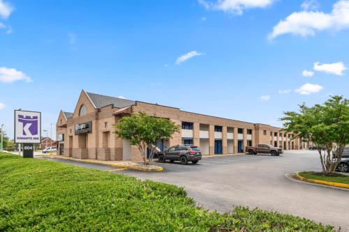 a building with cars parked in a parking lot at Knights Inn Virginia Beach Lynnhaven in Virginia Beach