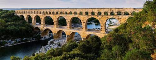 a bridge with many arches over a river at Le nid de Marie in Saint-André-de-Roquepertuis