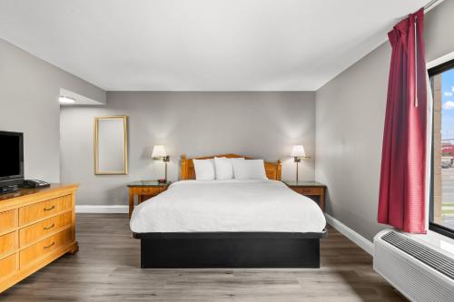 a hotel room with a bed and a television at Knights Inn Virginia Beach Lynnhaven in Virginia Beach