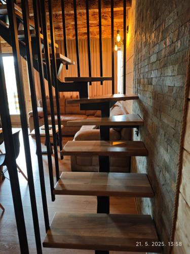 a set of stairs in a room with a brick wall at Vikendice Dream 1 in Sekulić 