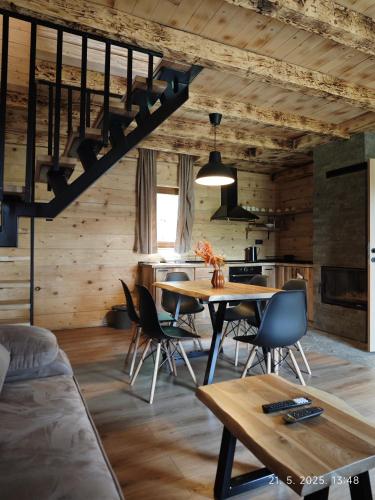 a kitchen and dining room with a table and chairs at Vikendice Dream 1 in Sekulić 