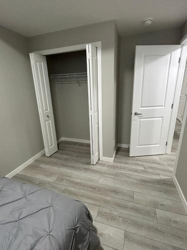 an empty room with two doors and a closet at Carssies Place in Calgary