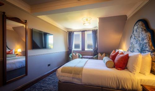 a hotel room with a bed and a mirror at Flodigarry Hotel in Staffin