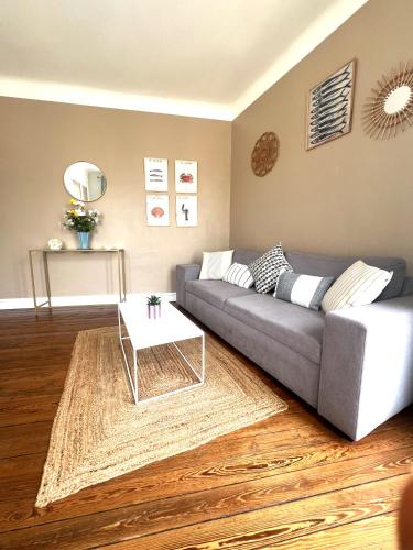un salon avec un canapé et une table basse dans l'établissement Le cosy Terminus - Le havre - 2 chambres -1 min à pied de la gare, au Havre