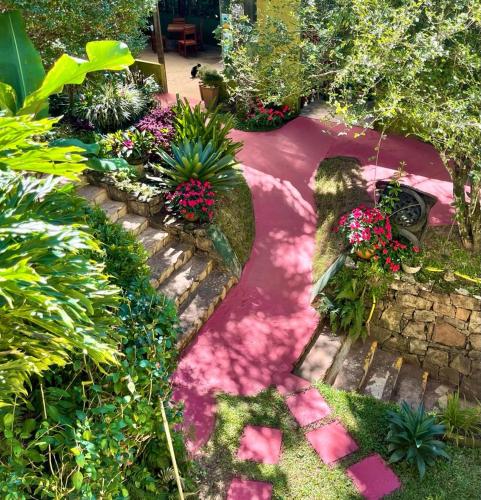 a garden with flowers and plants on a path at Cedros Pousada in Guaramiranga