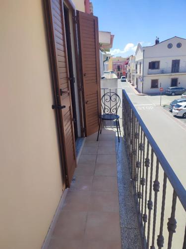a chair sitting on the balcony of a building at Casa al mare Portoscuso in Portoscuso