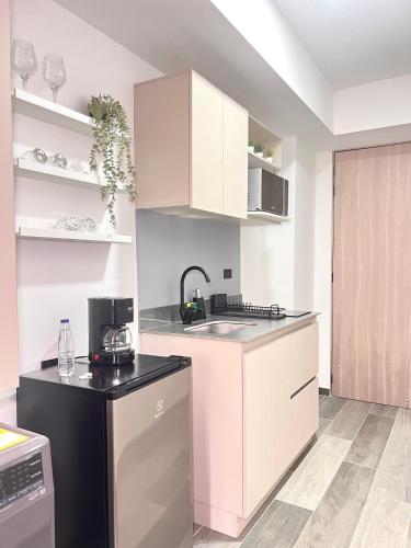 a kitchen with white cabinets and a sink at BIT by Simple stay in Medellín