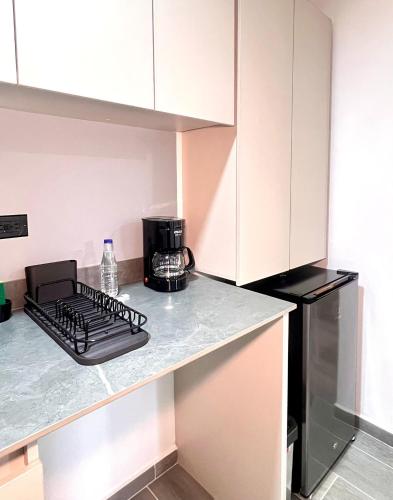 a kitchen with a counter top with a coffee maker at BIT by Simple stay in Medellín
