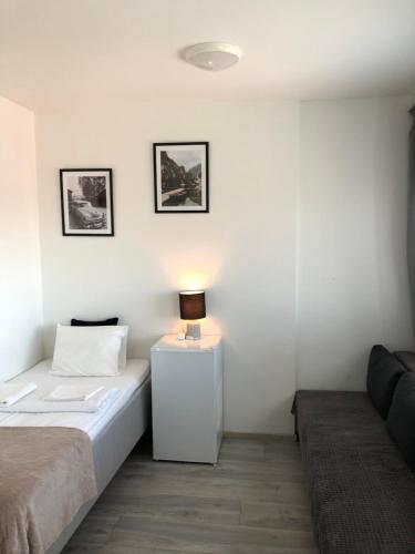 a bedroom with a bed and a lamp on a night stand at Inn Tourist Hostel in Helsinki