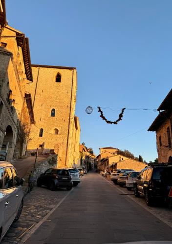 a street with cars parked on the side of a building at Giulivi Assisi Apartments in Assisi