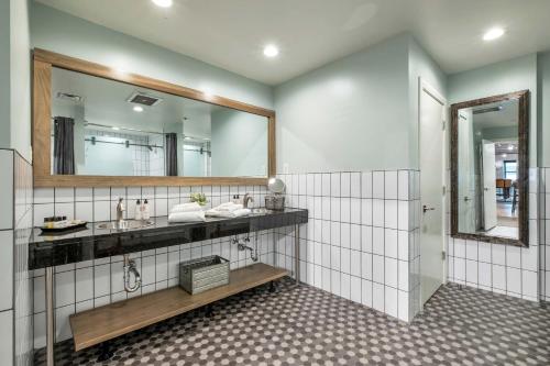 a bathroom with two sinks and a mirror at Nashville Honky Tonk Suite 6 BR by Maddox Hotel in Nashville