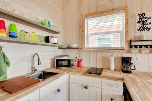 a kitchen with a sink and a microwave at Beachfront Cottage with Dock on Florida Gulf Coast in Lanark Village