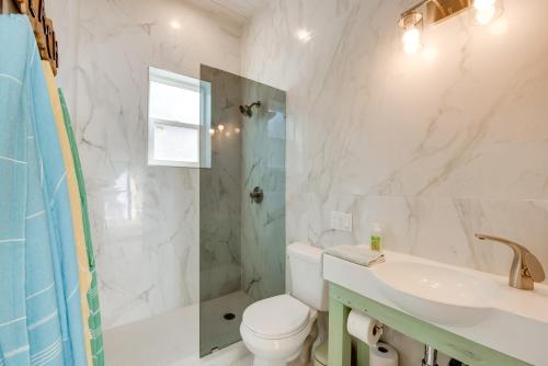 a bathroom with a toilet and a sink and a shower at Beachfront Cottage with Dock on Florida Gulf Coast in Lanark Village