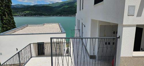 a balcony of a building with a view of a lake at Royal Terrace Konjic in Železnička Stanica Ostrožac