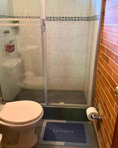 a bathroom with a shower with a toilet and a scale at Eco Boutique House in La Vega