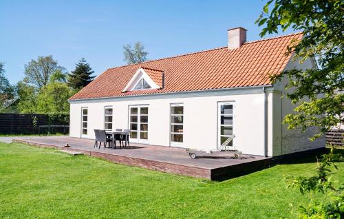 a white house with a wooden deck in the yard at 2 Bedroom Beautiful Home In Rude in Rude