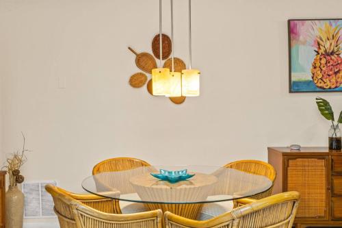 a dining room with a glass table and chairs at Pineapple Republic in Anona