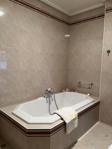 a bathroom with a bath tub with a sink at Montenegro Seaside Lux Apartment in Petrovac na Moru