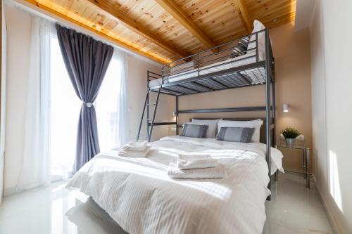 a bedroom with a large white bed with a metal canopy at RELAXING POOL HOUSE IN LAGONISI 1 in Kalívia Thorikoú