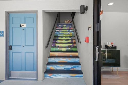 a staircase with a colorful carpet next to a blue door at Geary Parkway Motel in San Francisco
