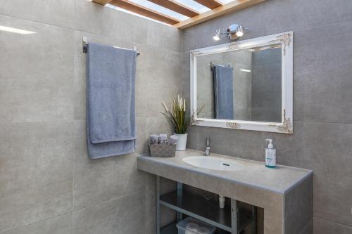 a bathroom with a sink and a mirror at RELAXING POOL HOUSE IN LAGONISI 1 in Kalívia Thorikoú