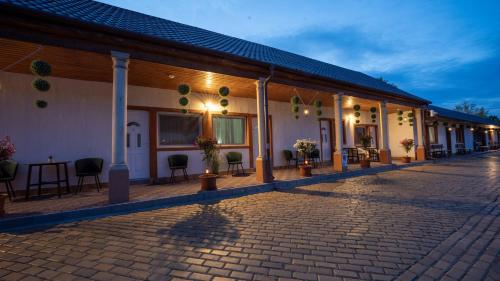 a building with a cobblestone street in front of it at Airport Károly Centrál in Vecsés