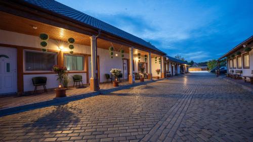 a cobblestone street in front of a building at Airport Károly Centrál in Vecsés