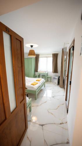 a room with a bedroom with a bed and a door at Airport Károly Centrál in Vecsés