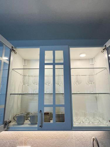 a glass cabinet with wine glasses in it at Las Cuatro Calles in Ribadeo
