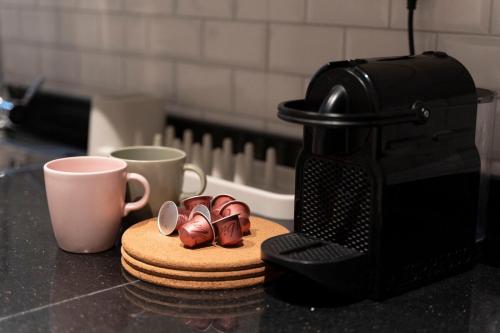 a pair of shoes on a cutting board next to a coffee maker at Apartment in Alkhoud Muscat in Maţār as Sīb ad Duwalī
