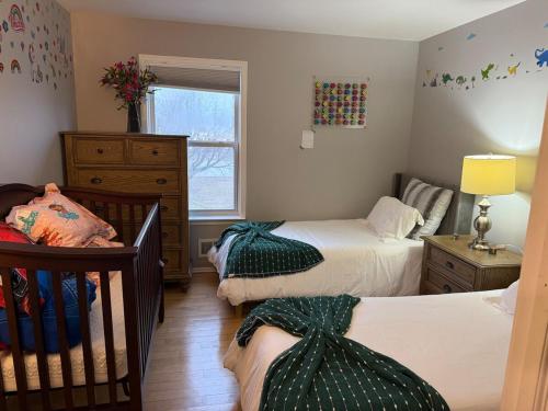 a bedroom with two twin beds and a window at Ground-level bed bath house1mi to the beach sleep8 in Long Branch