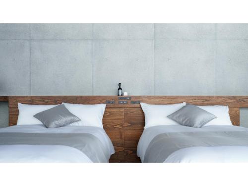 two beds sitting next to each other in a room at Tanegashima Araki Hotel Bekkan - Vacation STAY 57000v in Nishinoomote