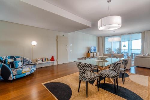 a dining room and living room with a table and chairs at Suite 107 in Funchal