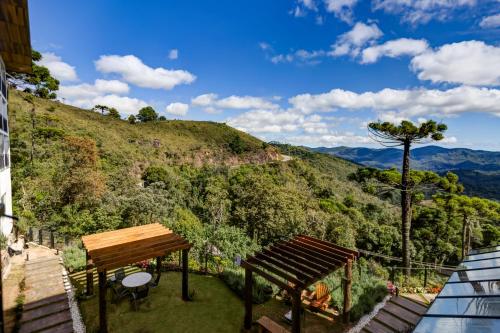 a balcony with a view of a mountain at Gran Paradiso Campos do Jordão By Ventura OFICIAL in Campos do Jordão