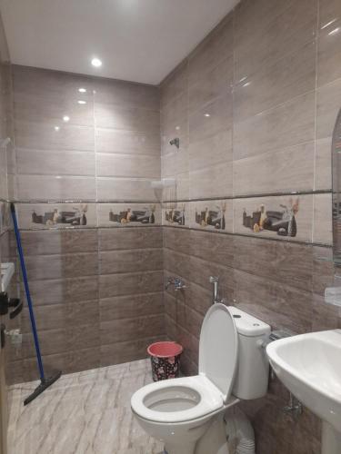 a bathroom with a toilet and a sink at diki ksar sghir in Oulad Akkou