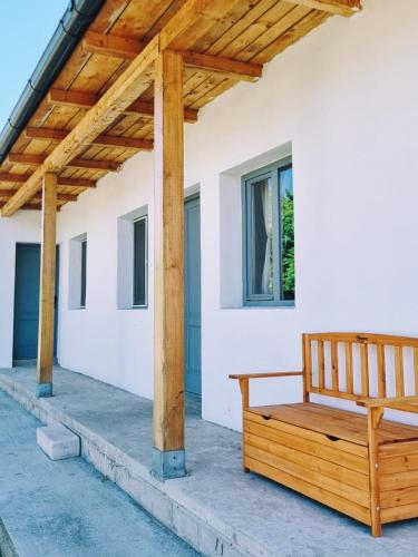 a wooden bench on the porch of a house at Casa LuMINA in Greci