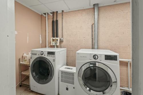 two washing machines sitting next to each other in a room at Lakeview Retreat w Kayaks Game Room Firepits Gated Community w Lake Beach Access in East Stroudsburg