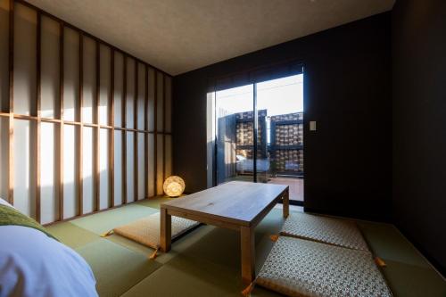 a room with a table in front of a window at Itoshima Resort TUMUGU - Vacation STAY 18230 in Fukuoka