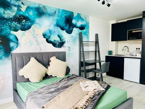 a bedroom with a bed and a kitchen at Anjaneya Homes - Double Room En-suites with Kitchenette in Ashford