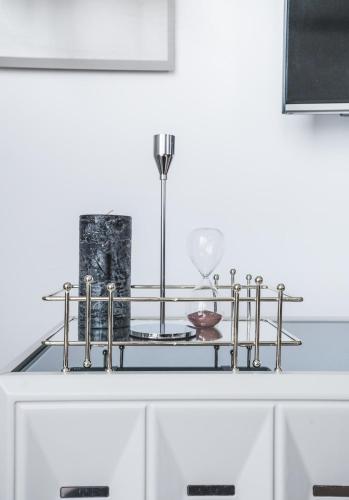 a table with a shelf with a glass top at Stylish 28F Gym Free Pkg Secured in Skopje