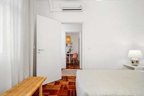 a bedroom with a bed and a dining room at Live, Love and Laugh in Funchal