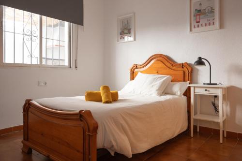 a bedroom with a bed with a stuffed animal on it at Villa Biznaga in Rincón de la Victoria