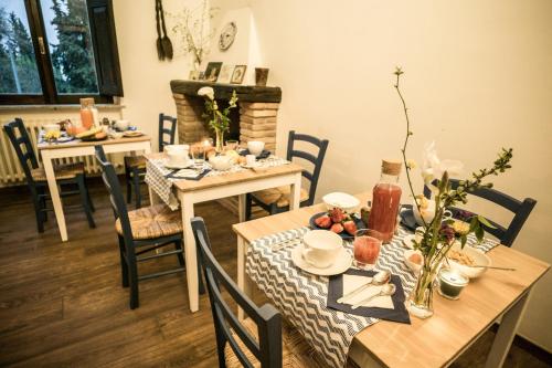 a dining room with tables and chairs with food on them at Dimora Amina in Loreto Aprutino