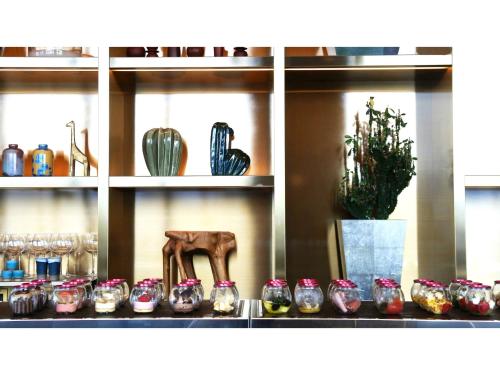 a shelf filled with lots of vases and cactuses at THE KNOT HIROSHIMA - Vacation STAY 32485v in Hiroshima