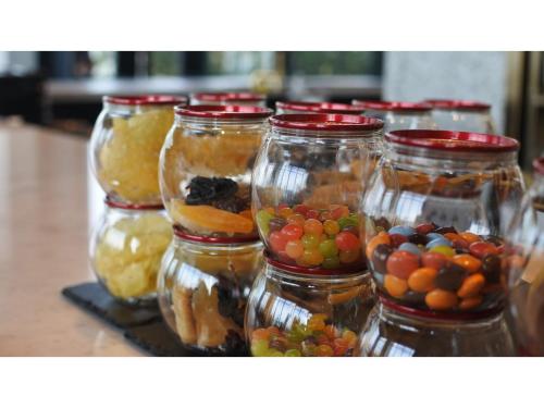 a group of jars filled with different types of fruit at THE KNOT HIROSHIMA - Vacation STAY 32485v in Hiroshima