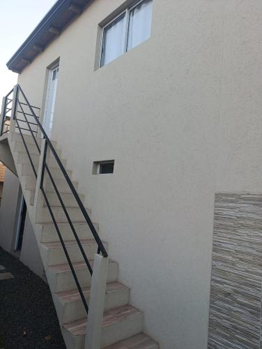 a stairway leading up to a white building at Los Colibríes 2 in San José