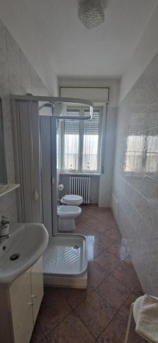 a bathroom with two sinks and two toilets in it at Cristal Appartament in Brindisi
